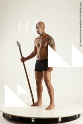 Underwear Fighting with spear Man Black Sitting poses - simple Muscular Bald Sitting poses - ALL Multi angles poses Academic