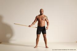 Sportswear Man Black Muscular Bald Dynamic poses Academic