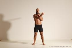 Sportswear Man Black Muscular Bald Dynamic poses Academic